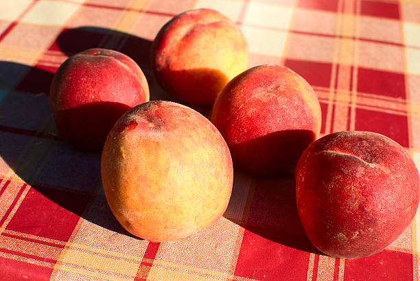 Peaches on the kitchen table stock photo