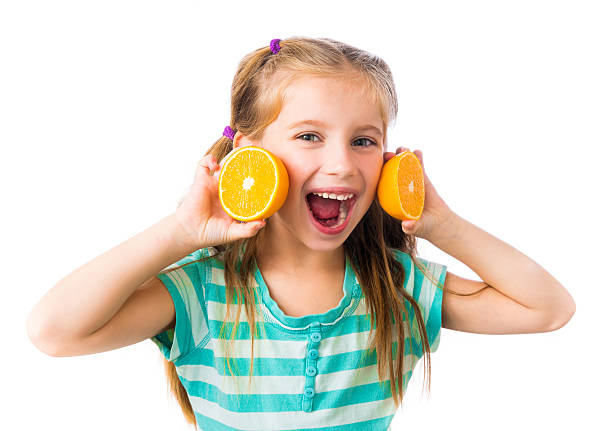 istock little girl with oranges 464598255