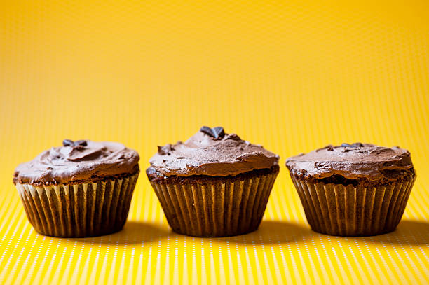 istock three chocolate velvet cupcakes with dark ice cream 464610773
