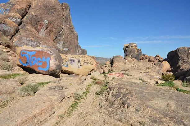 Photo of Graffiti Covered Boulders in California Desert