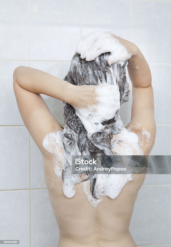Young woman bathing Portrait of a young woman bathing in bathroom Human Hair Stock Photo