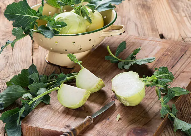 Fresh  kohlrabi with knife on a wooden table