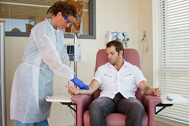 Nurse preparing patient for chemotherapy Nurse attaching intravenous for patient chemotherapy infused stock pictures, royalty-free photos & images