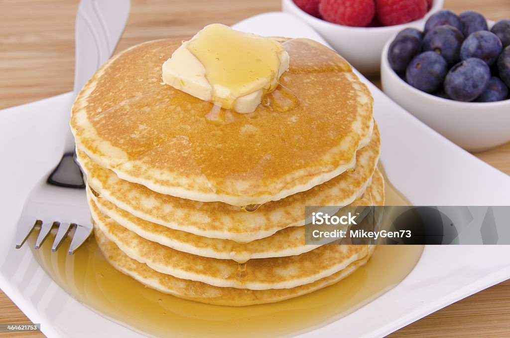 Stack of pancakes Stack of pancakes with fruits on background. Top view. Butter Stock Photo