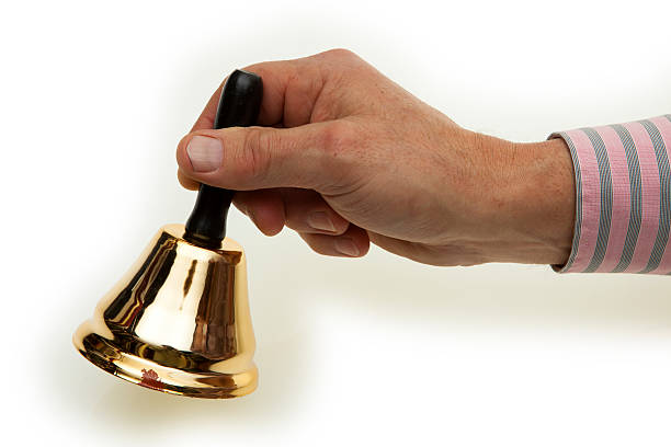 istock Hand of a man with brass bells 464622445