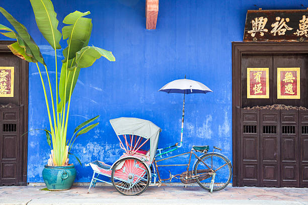 Old rickshaw tricycle near Fatt Tze Mansion, Penang, Malaysia. stock photo