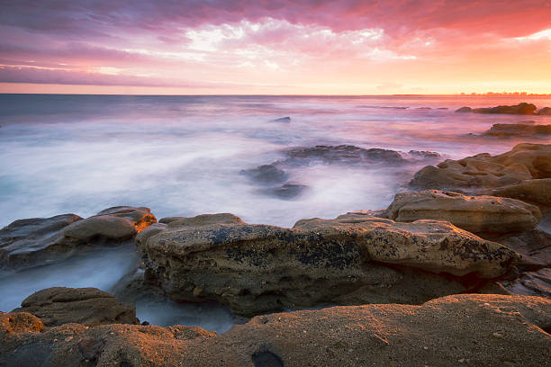 istock Rocks and waves at Kings Beach, QLD. 464627110