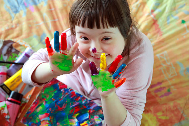 little girl with painted hands