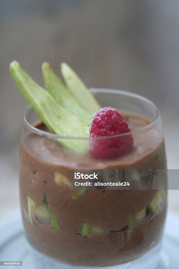 Chocolate avocado mousse with a raspberry garnish A chocolate & avocado mousse dessert topped with a raspberry & avocado garnish Avocado Stock Photo