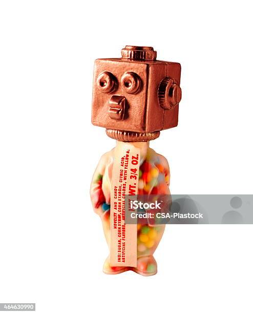 Bronze Robot With Candy Filled Body Stock Photo - Download Image Now - 2015, Candy, Colored Background