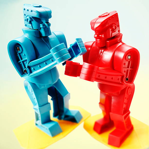 Red and Blue Robots Fighting stock photo