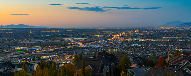 Draper Utah at Dusk Draper Utah at dusk with I-15 traffic leading North to Salt Lake City.  The illuminated Oquirrh Mountain LDS Temple can be seen in the distance on the left. mormonism photos stock pictures, royalty-free photos & images