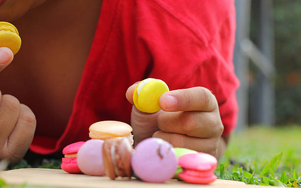 istock Kid eating french macaroons is delicious 464635912