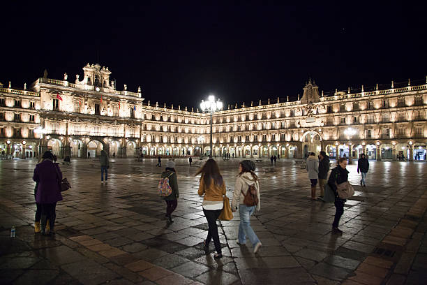 \nSalamanca, Spain January 26, 2015:  A central place in the city, the Plaza Mayor at night whit some people walking \n