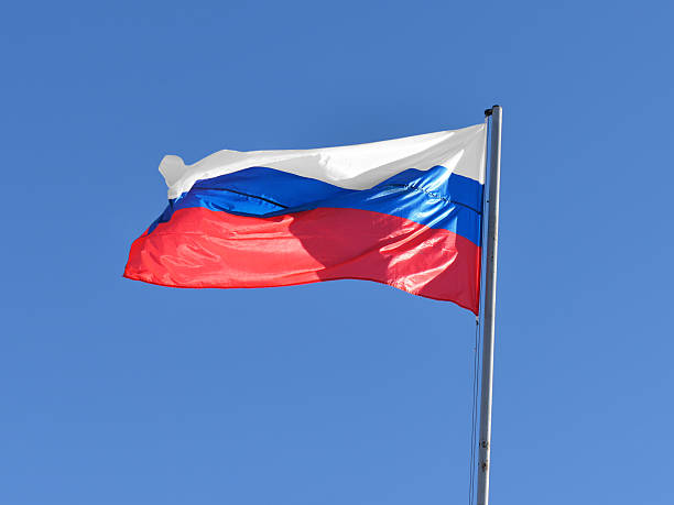 istock Russian flag waving against blue sky 464640232