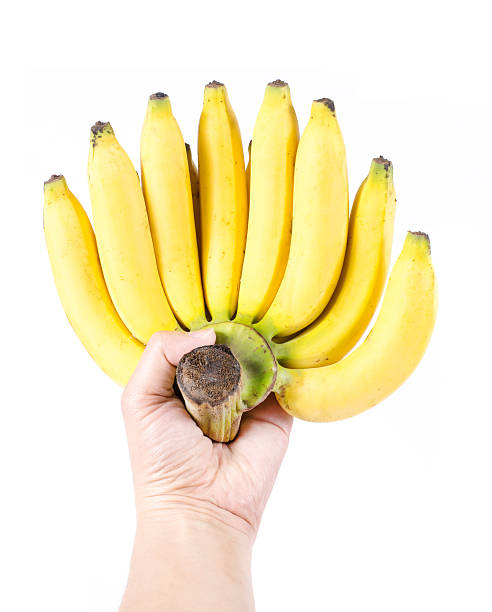 man mano con casco di banane, isolato su sfondo bianco - men banana holding cut out foto e immagini stock