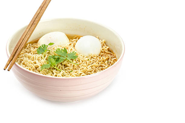 Noodles with boiled eggs in bowl and chopsticks isolated on white background