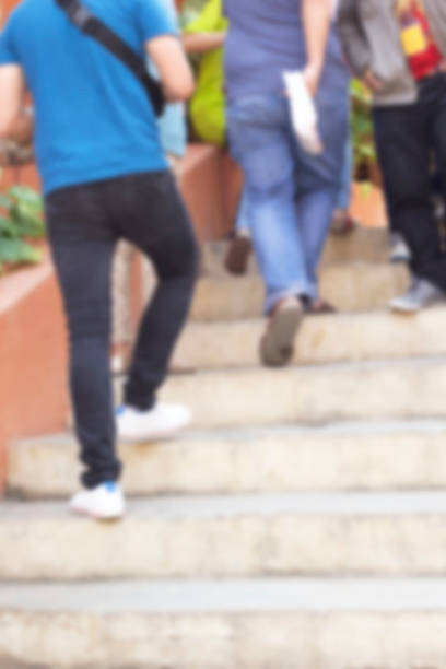 istock Blurred of people walking in park 464644348