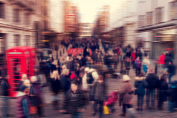 a defocused blur background of people walking in a street in London, United Kingdom