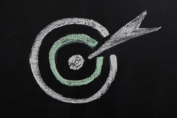 istock Chalked target and arrow in it on chalkboard 464646924