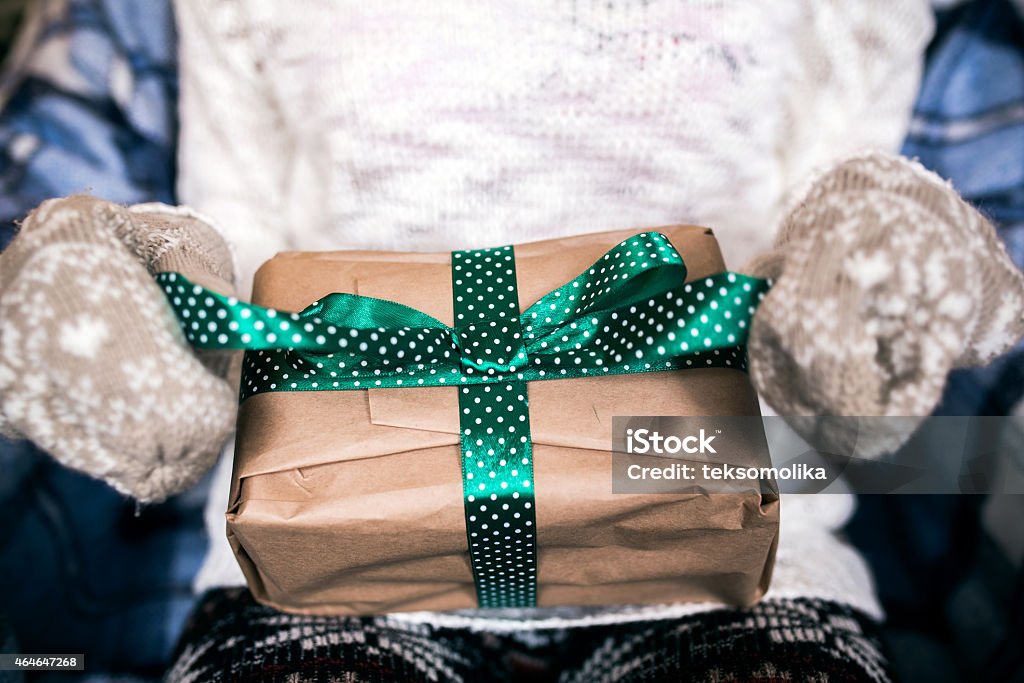 Girl opens gift Girl opens a wonderful vintage gift 2015 Stock Photo