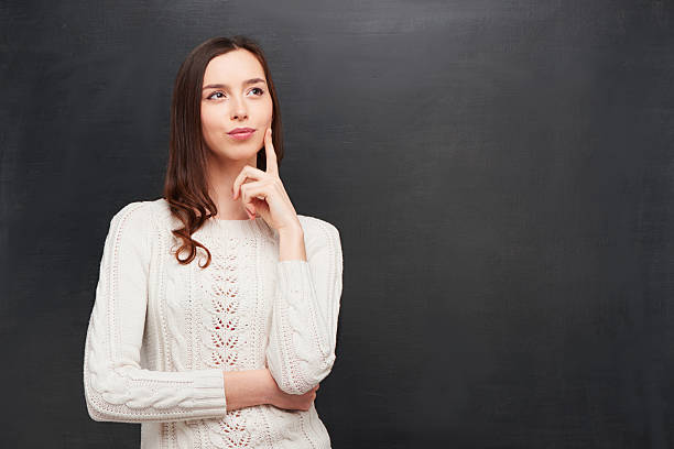 istock Thoughtful woman on chalkboard background 464650038