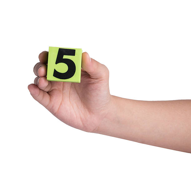 istock Hand holind colorful plastic numbers on a white background 464653258