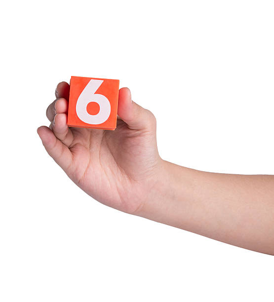 istock Hand holind colorful plastic numbers on a white background 464653264
