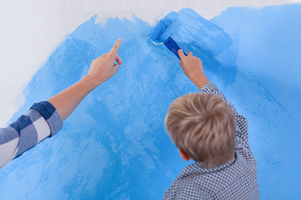 istock Little boy painting his room 464653480