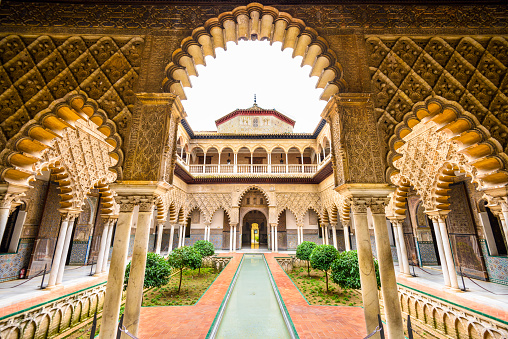 Seville, Spain - November 7, 2014: The Royal Alcazar of Seville at the Courtyard of the Maidens. It is the oldest royal palace still in use in Europe.