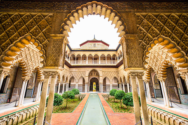 Alcazar of Seville Seville, Spain - November 7, 2014: The Royal Alcazar of Seville at the Courtyard of the Maidens. It is the oldest royal palace still in use in Europe. seville photos stock pictures, royalty-free photos & images