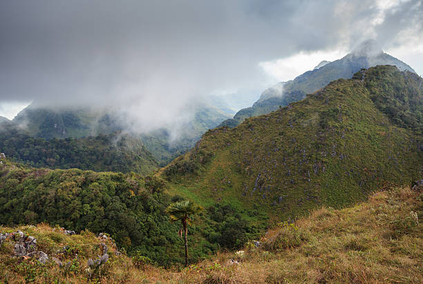 istock mountain peak and raining fog blue sky 464657770