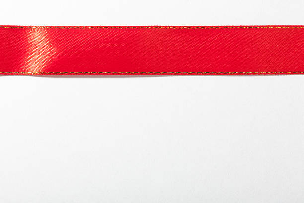 istock Shiny red ribbon on white background with copy space. 464658599