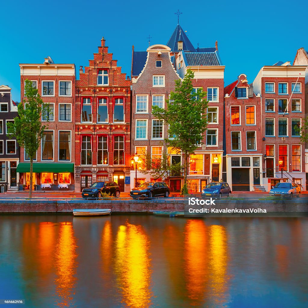 Night city view of Amsterdam canal with dutch houses Night city view of Amsterdam canal Herengracht, typical dutch houses and boats, Holland, Netherlands. 2015 Stock Photo