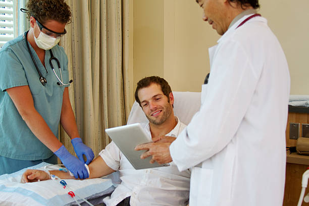 Patient is pleased with test results Patient is pleased with test results that doctor is showing him dialysis photos stock pictures, royalty-free photos & images