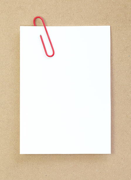 istock Red metal paper clip and blank white paper note 464663526