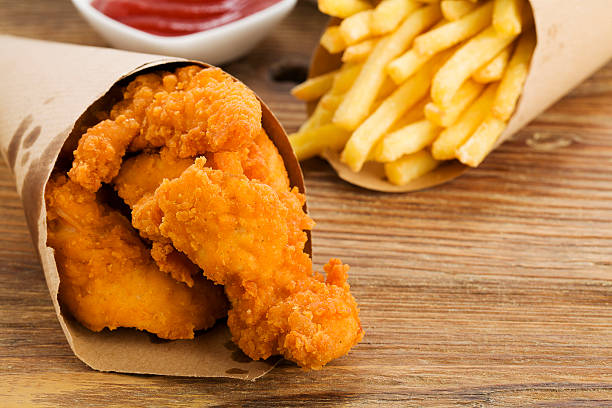 istock Nuggets and chips served in a paper bag with dips 464663980
