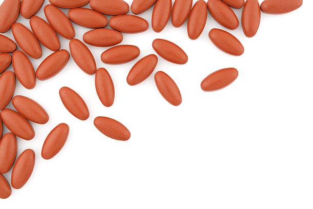 istock bunch of red brown pills on white background 464667380