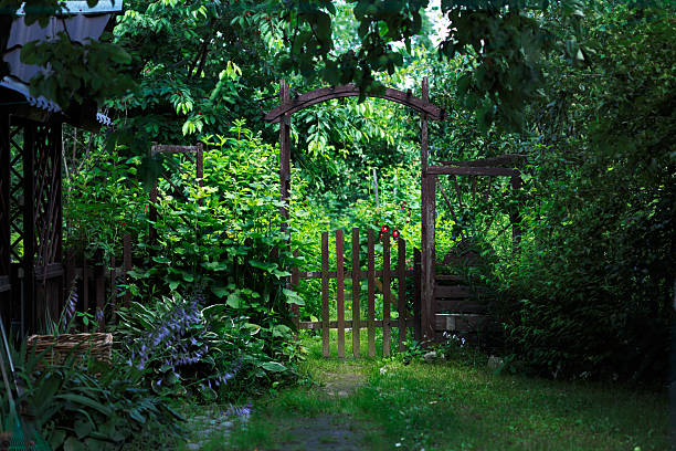 Garden gate A gate to a green blooming garden in the middle of a warm summer iron county wisconsin stock pictures, royalty-free photos & images