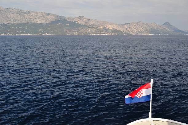 istock Croatian national flag flying at windy day 464669809