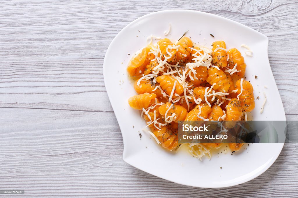 pumpkin gnocchi with cheese and spices. horizontal top view pumpkin gnocchi with cheese and spices on the plate closeup. horizontal top view Gnocchi Stock Photo