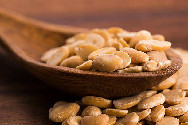 istock broad bean dry on wooden table 464671066