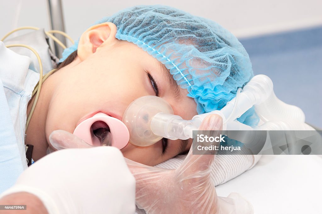 Child patient receiving artificial ventilation Portrait of child patient receiving artificial ventilation in hospital 2015 Stock Photo