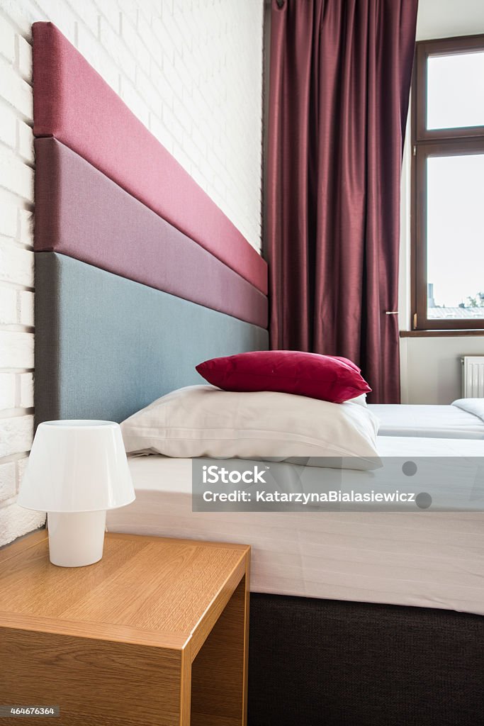 Bed with colourful headboard Twin bed in hotel with colourful headboard 2015 Stock Photo