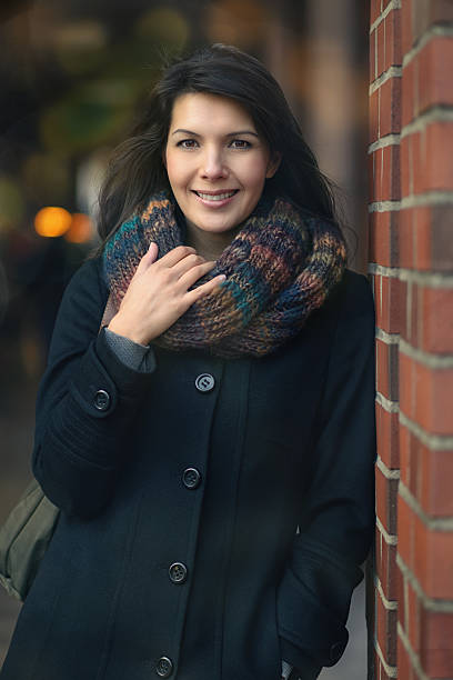 istock Stylish Pretty Woman Leaning on a red brick pillar 464676368