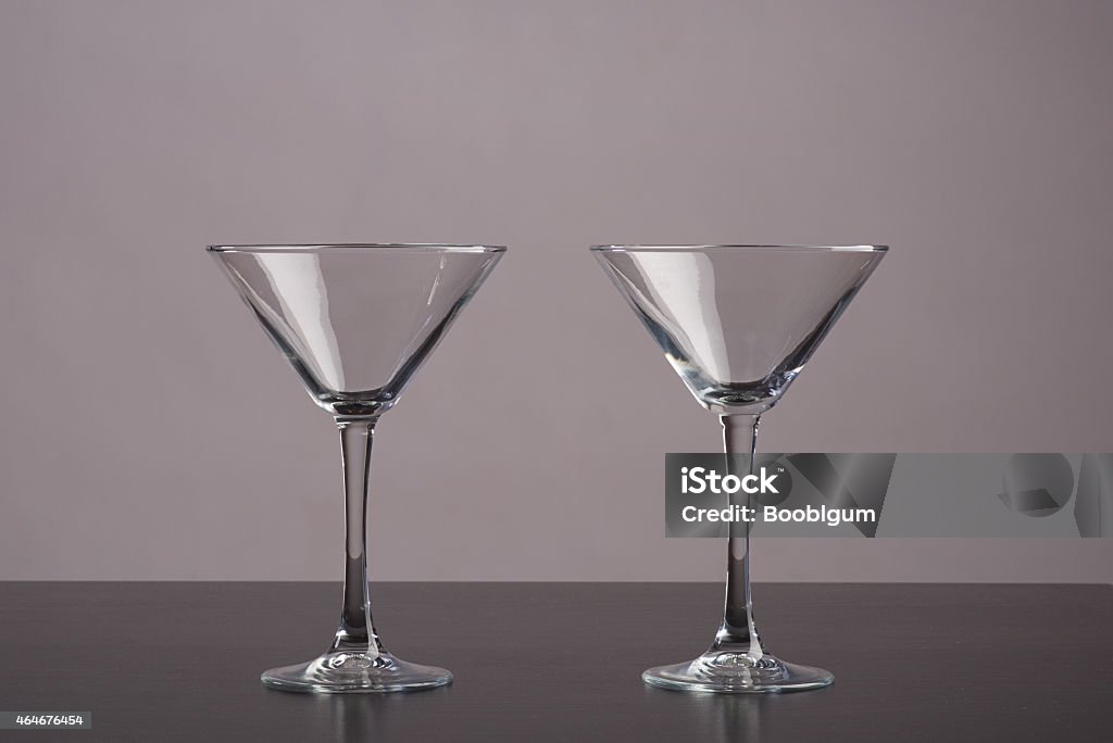 Martini glass Two Martini glasses standing on dark table 2015 Stock Photo