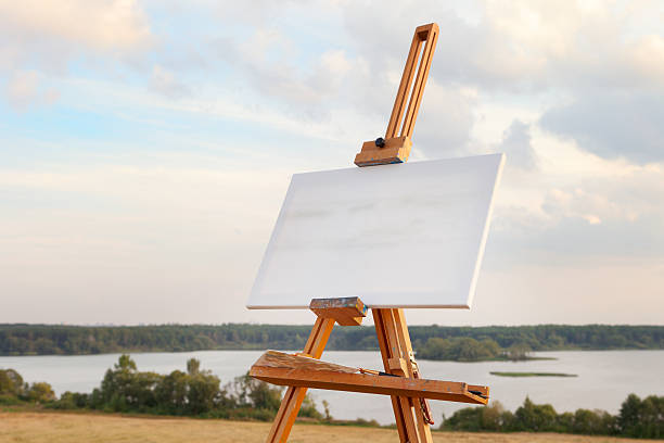 istock blank canvas rests on a easel,  lake landscape 464676695