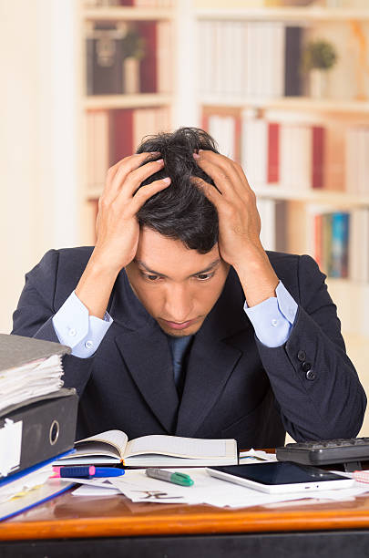 istock young stressed overwhelmed man with piles of folders on his 464678588