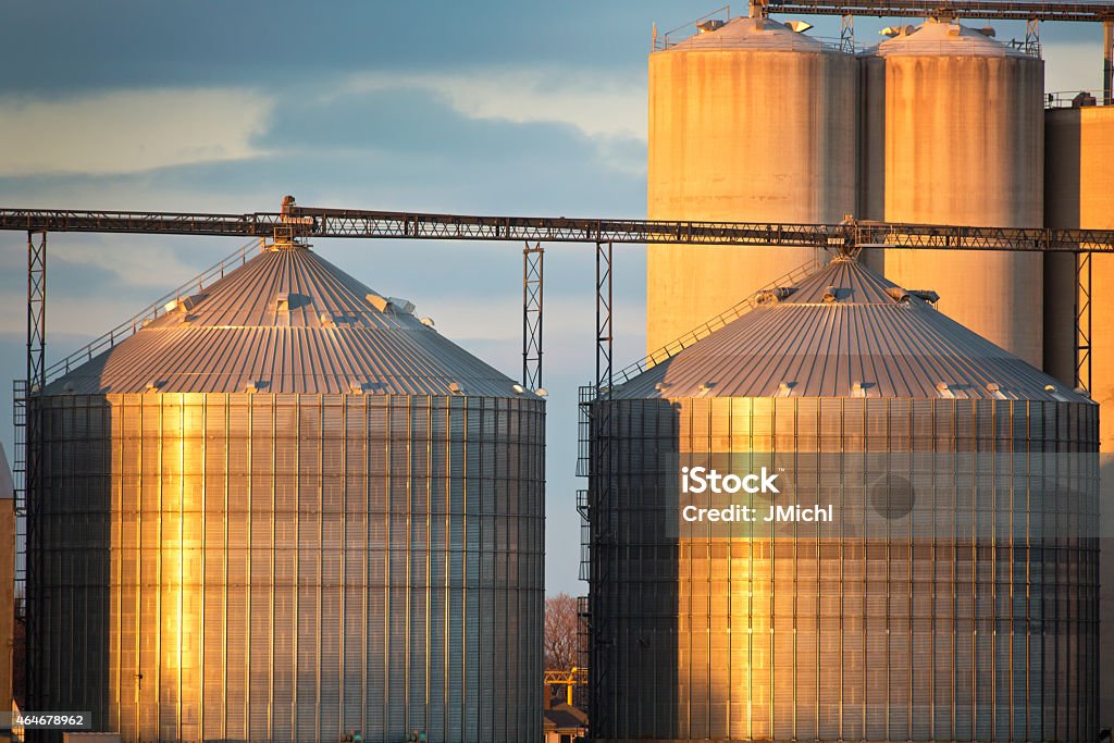 Grain Elevator in The Midwest With Sunset Reflection. Grain storage bins in the midwest. 2015 Stock Photo