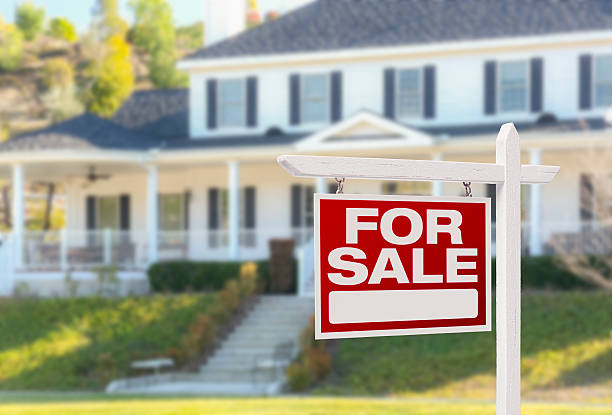 Home For Sale Sign in Front of New House Home For Sale Real Estate Sign in Front of Beautiful New House. real estate sign photos stock pictures, royalty-free photos & images